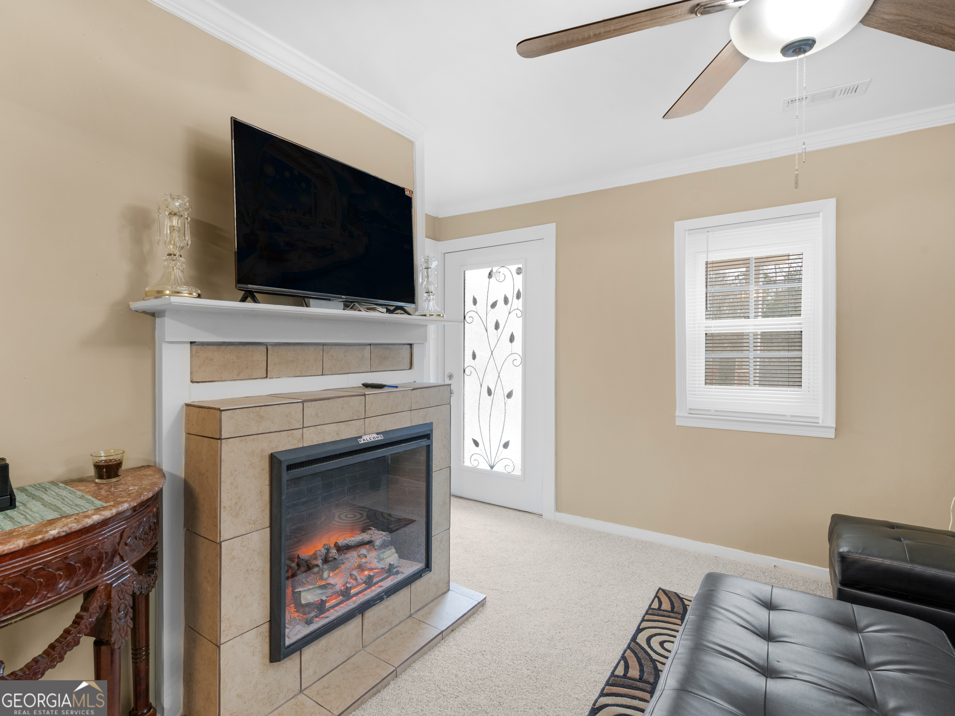 149 Akins Street Barnesville, GA 30204 - Photo 3 of 27 a living room with furniture a flat screen tv and a fireplace