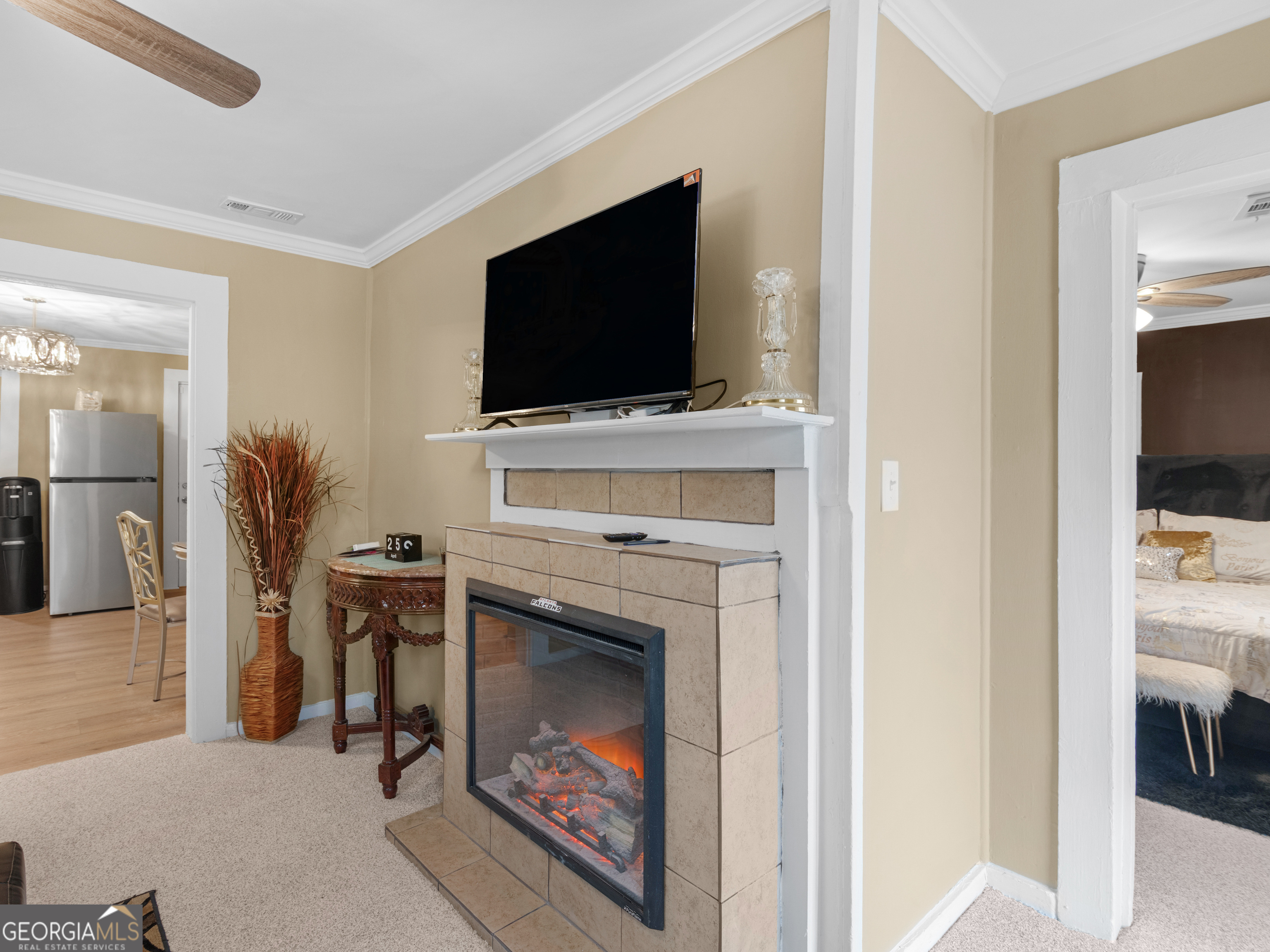 149 Akins Street Barnesville, GA 30204 - Photo 4 of 27 a living room with furniture a flat screen tv and a fireplace