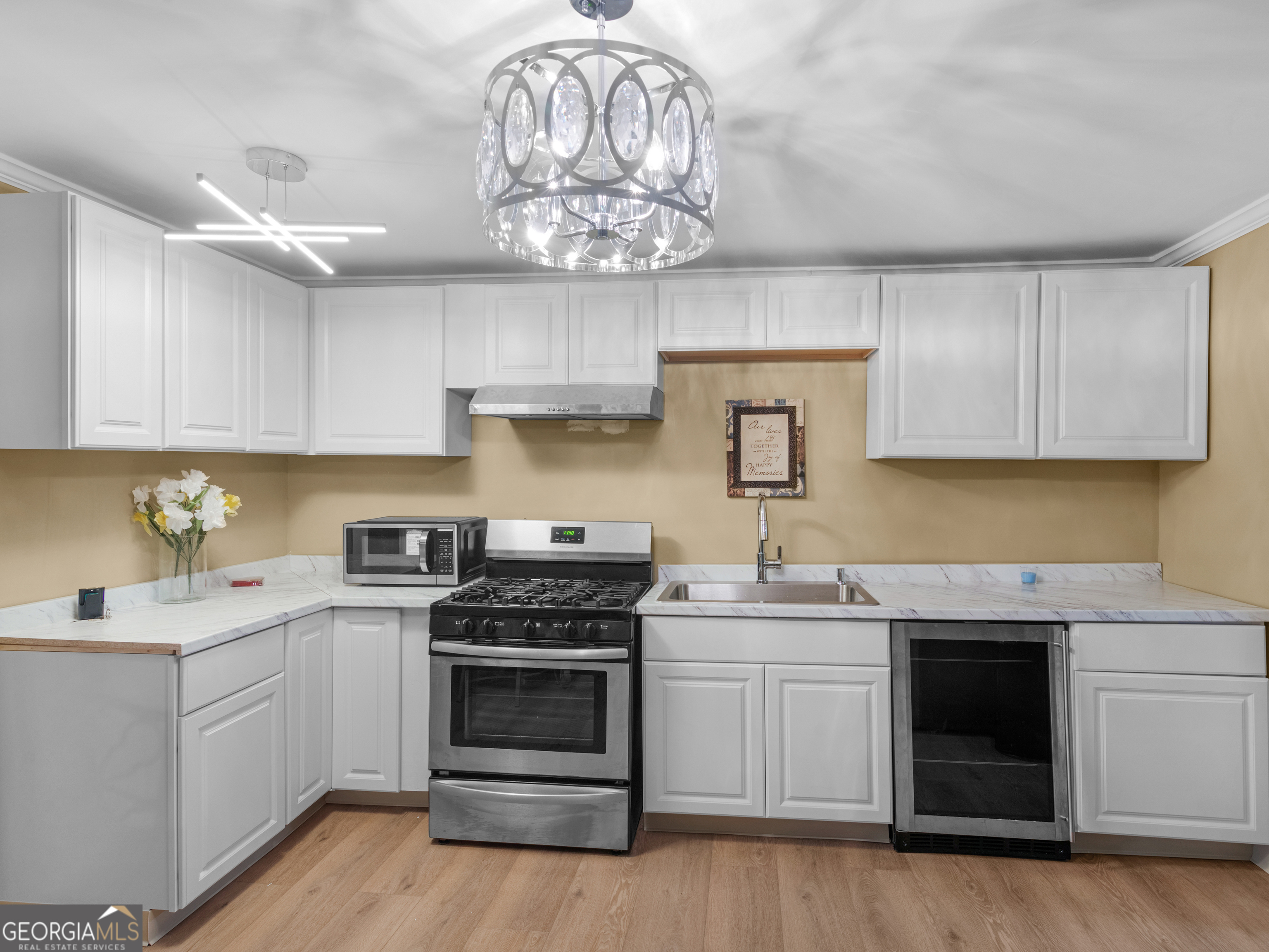 149 Akins Street Barnesville, GA 30204 - Photo 7 of 27 a kitchen with a sink stove and cabinets