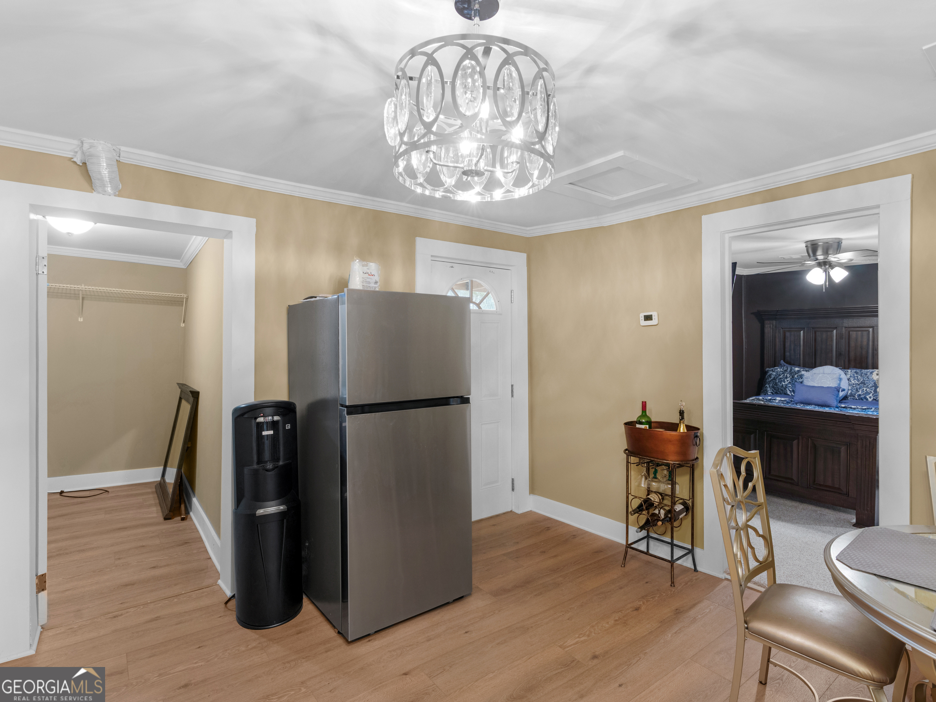 149 Akins Street Barnesville, GA 30204 - Photo 9 of 27 a kitchen with a refrigerator a dining table and chairs