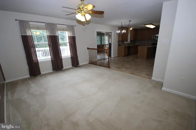 a view of a room with a dining table and chairs