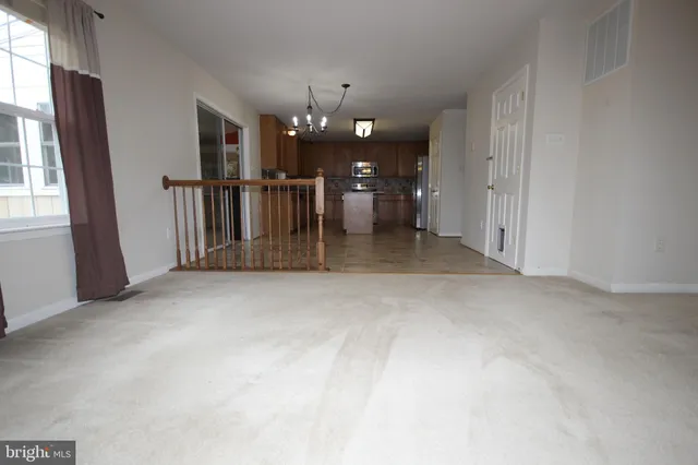 an empty room with entrance and windows