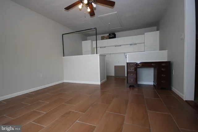 a view of an empty room with a fireplace