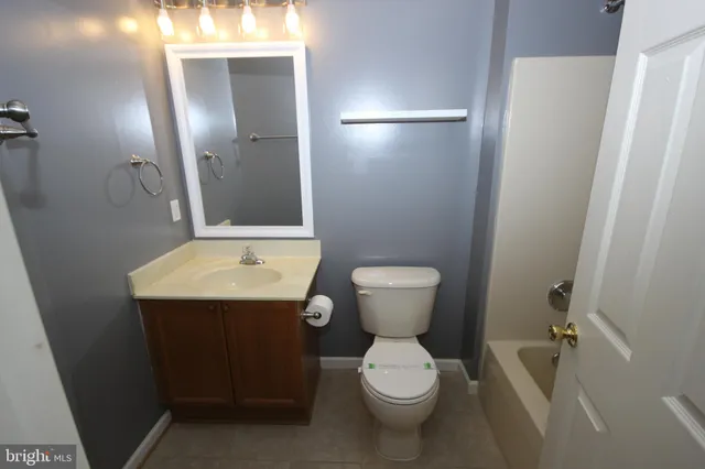 a bathroom with a toilet and a bathtub