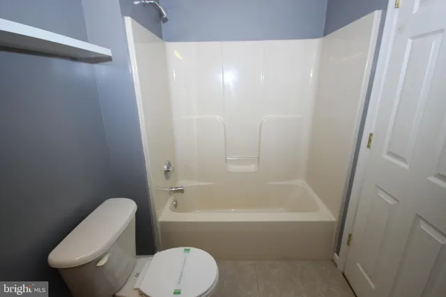 a bathroom with a toilet a sink and vanity