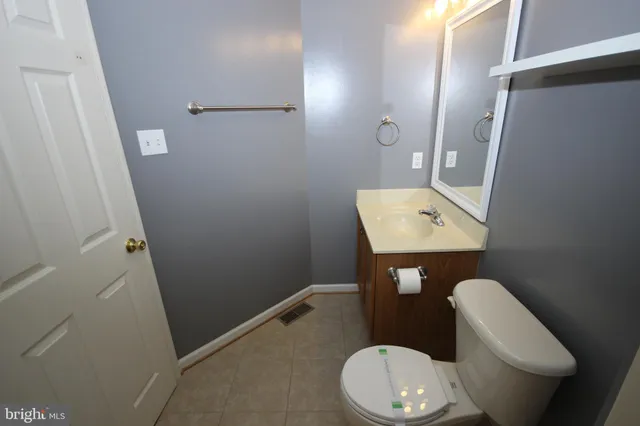 an empty room with closet and wooden door