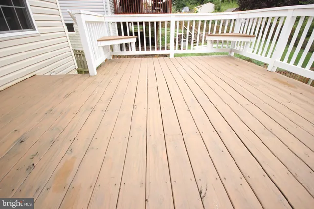 a view of a house with a yard and fence