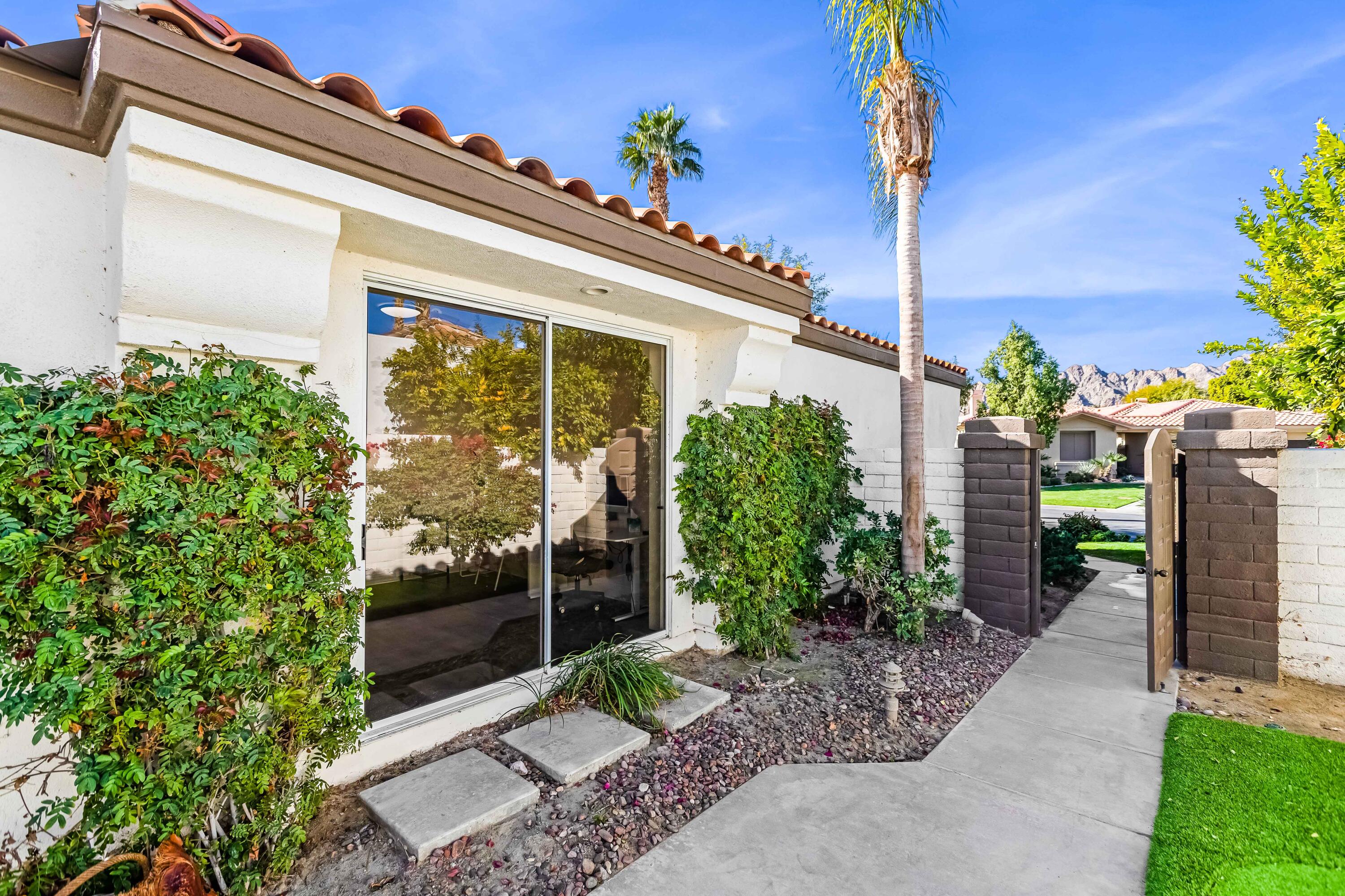 57600 Interlachen La Quinta, CA 92253 - Photo 13 of 87 a front view of a house with a garden