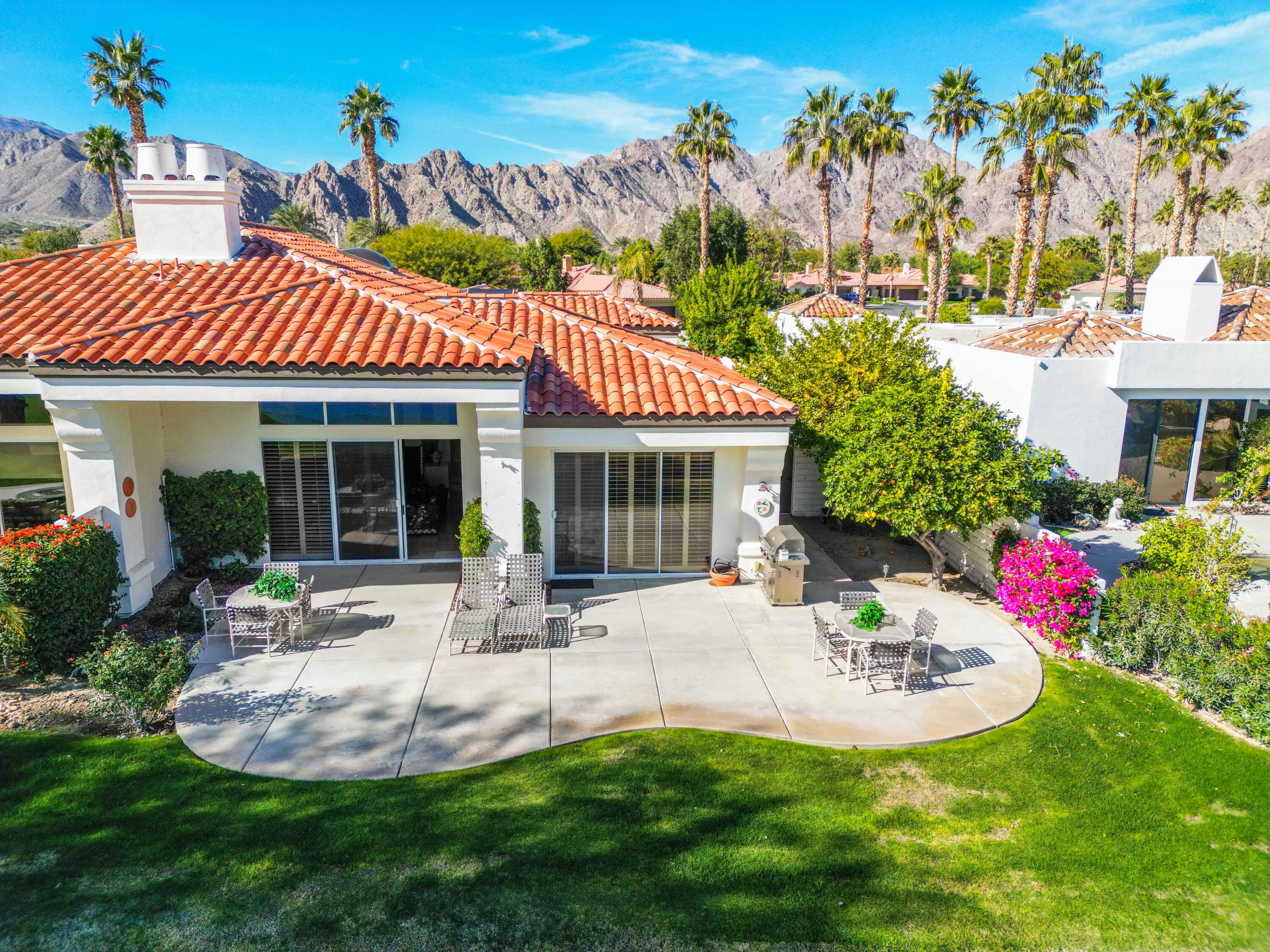 57600 Interlachen La Quinta, CA 92253 - Photo 18 of 87 a front view of a house with a garden and patio