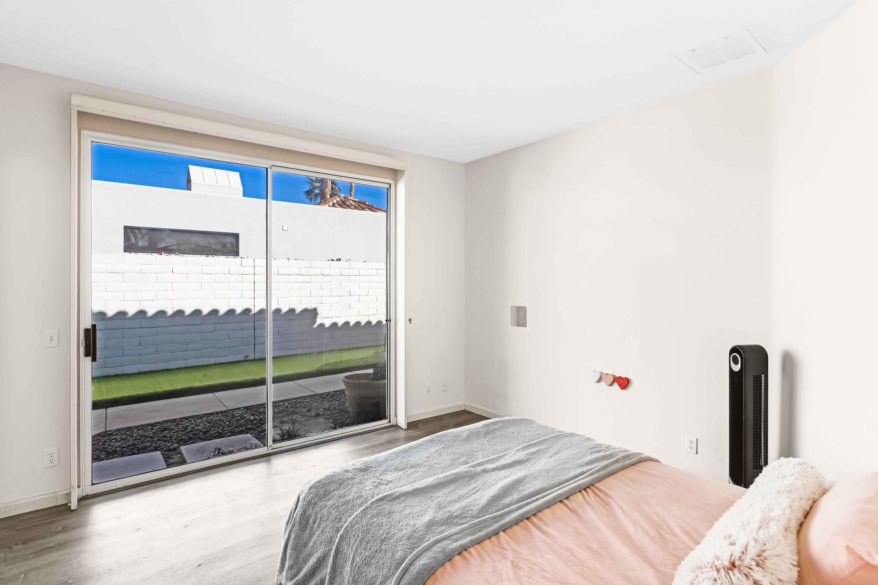 57600 Interlachen La Quinta, CA 92253 - Photo 22 of 87 a bedroom with a bed and a large window