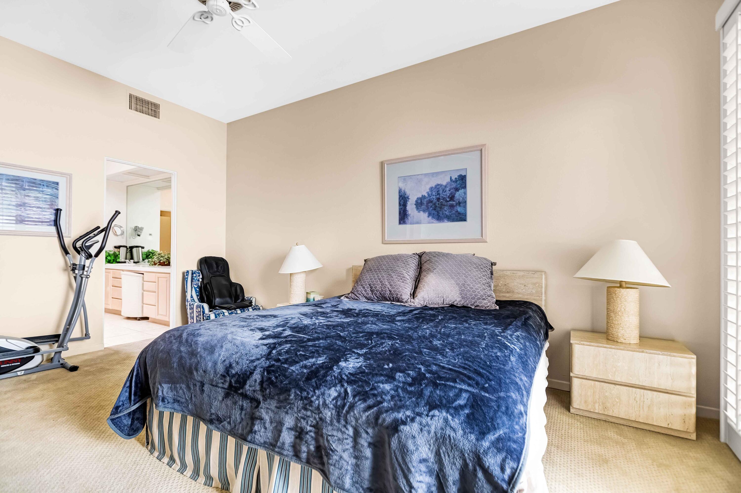 57600 Interlachen La Quinta, CA 92253 - Photo 27 of 87 a spacious bedroom with a bed a couch and a table