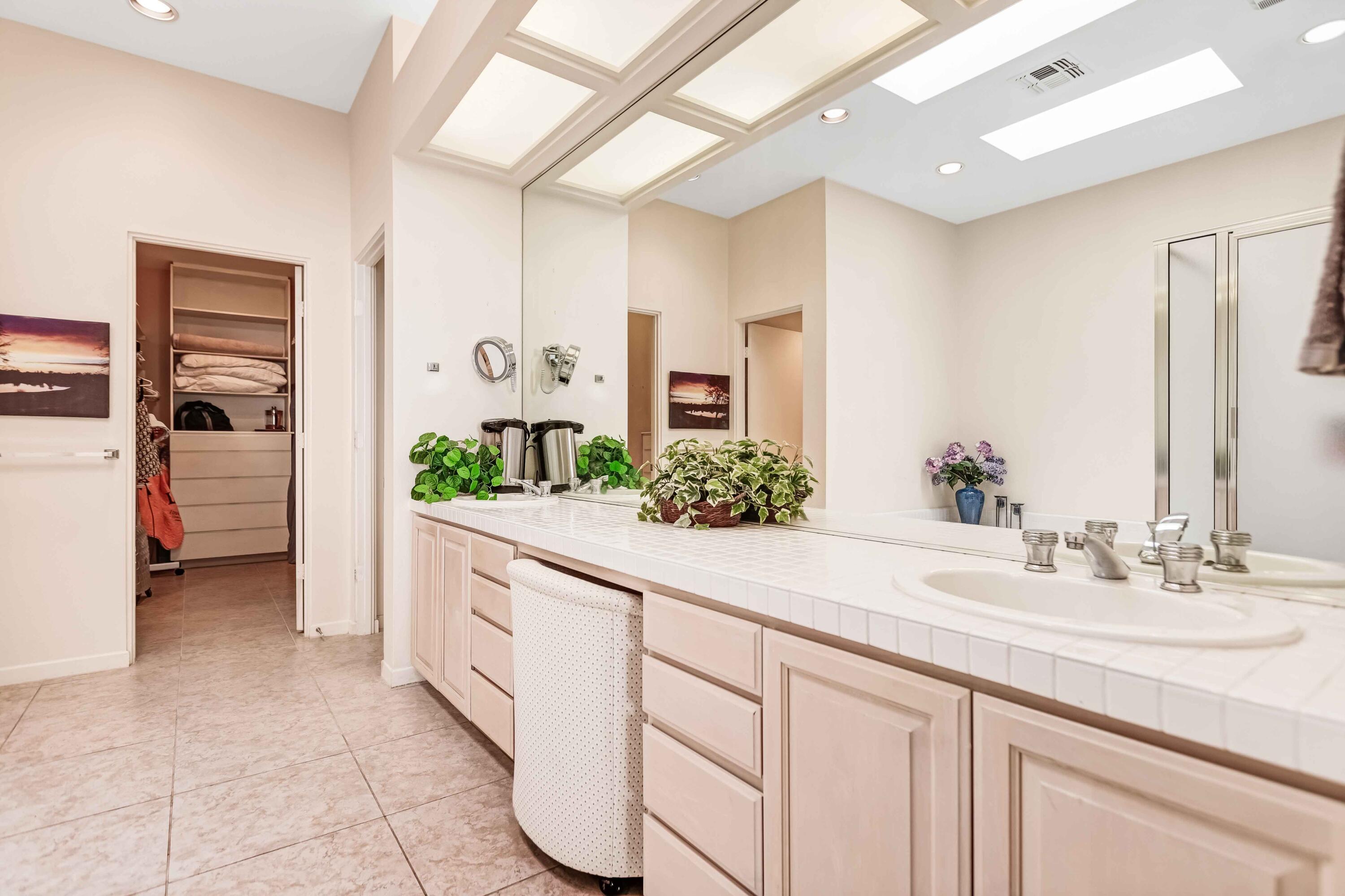 57600 Interlachen La Quinta, CA 92253 - Photo 33 of 87 a spacious en suite bathroom with a granite countertop sink and a mirror