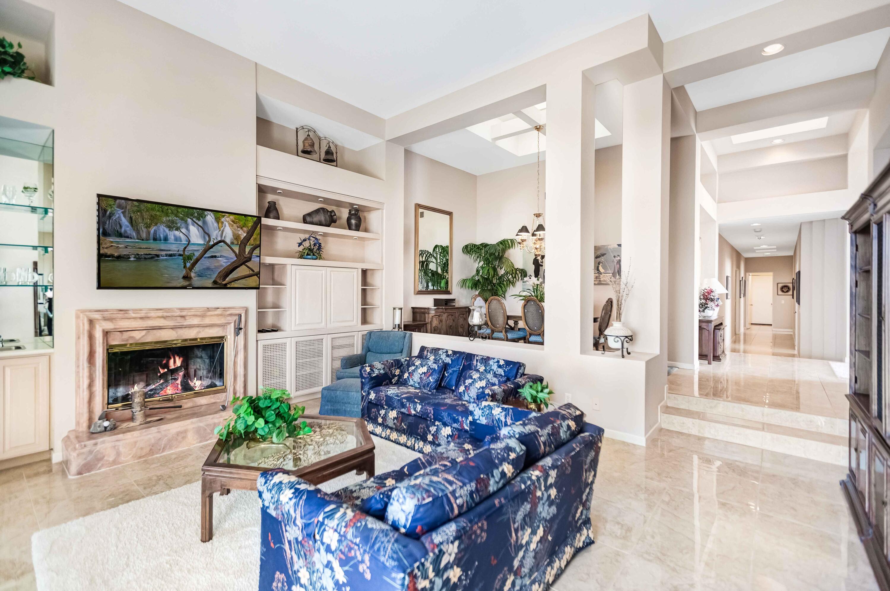 57600 Interlachen La Quinta, CA 92253 - Photo 51 of 87 a living room with furniture a flat screen tv and a fireplace