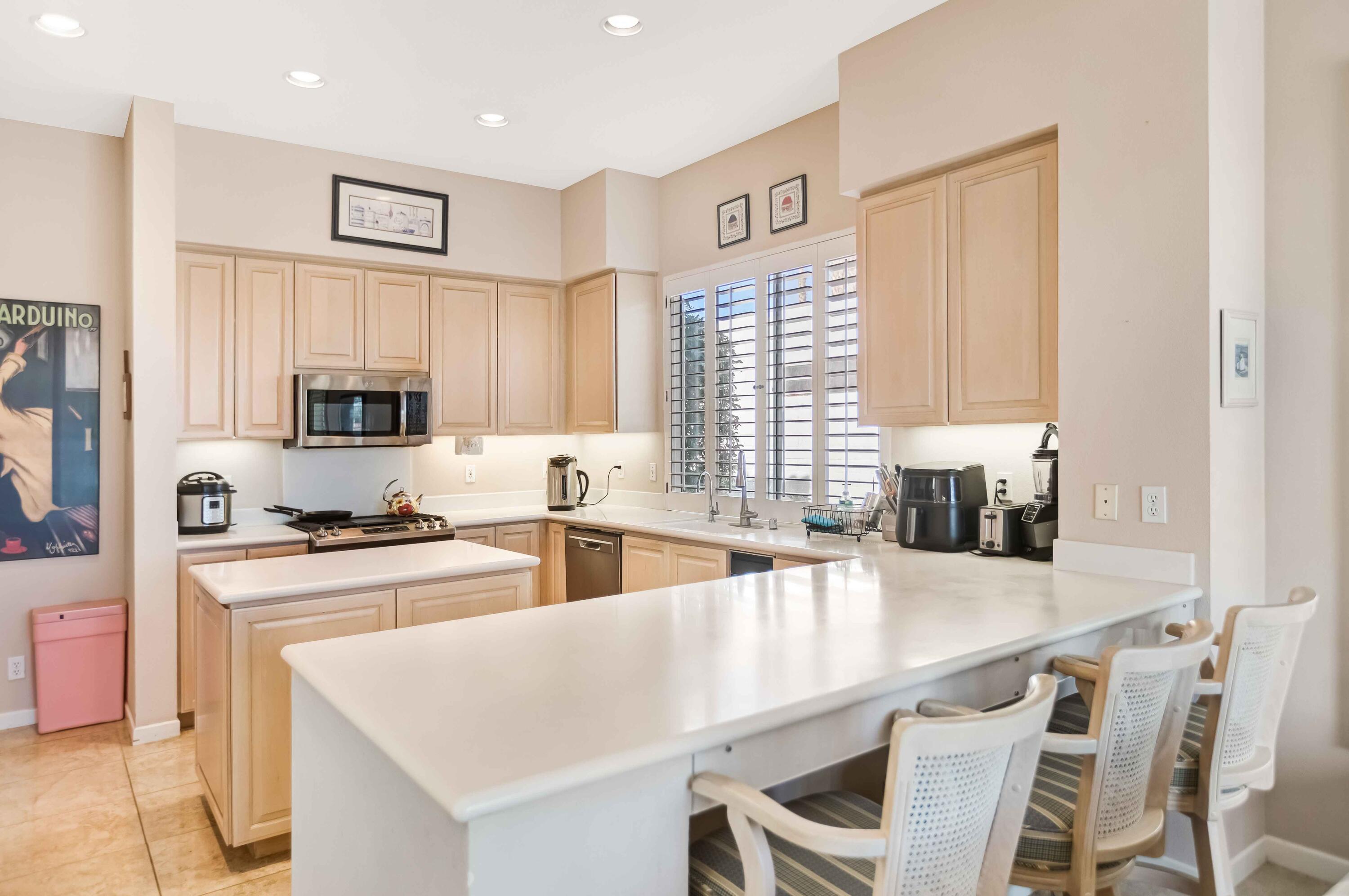 57600 Interlachen La Quinta, CA 92253 - Photo 61 of 87 a kitchen with a stove a sink and a refrigerator