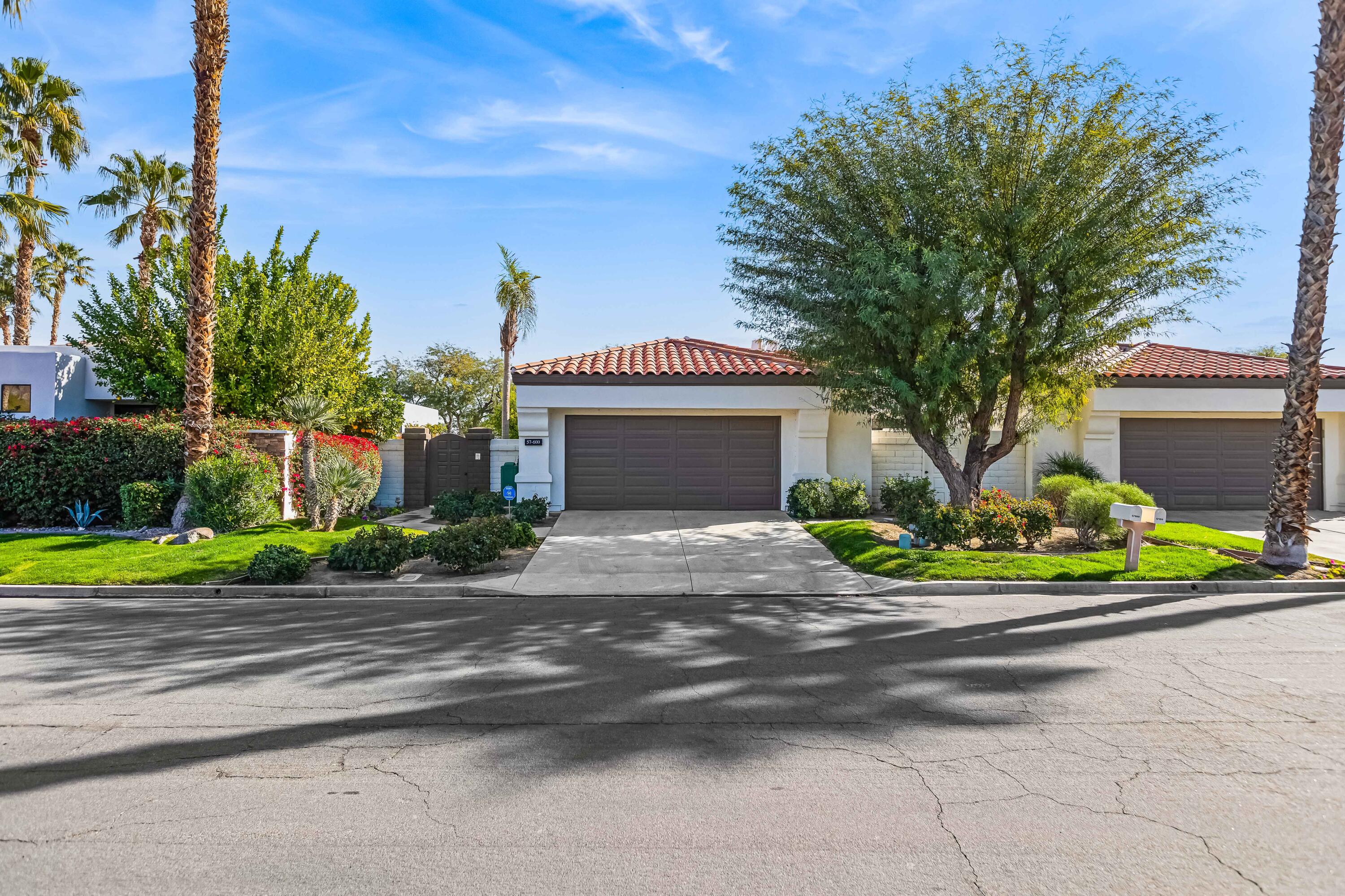 57600 Interlachen La Quinta, CA 92253 - Photo 66 of 87 a front view of a house with a garden and trees