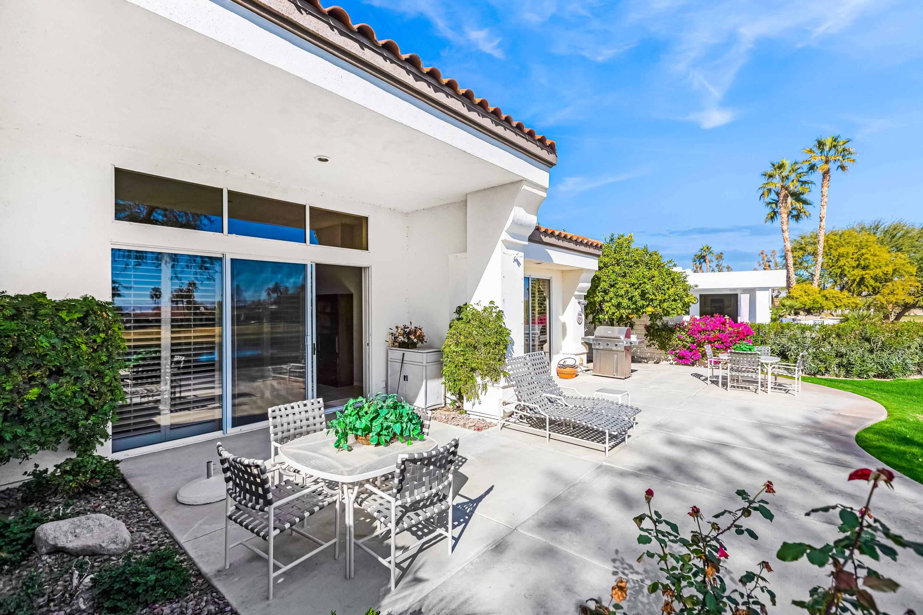 57600 Interlachen La Quinta, CA 92253 - Photo 74 of 87 a view of a patio with table and chairs and potted plants