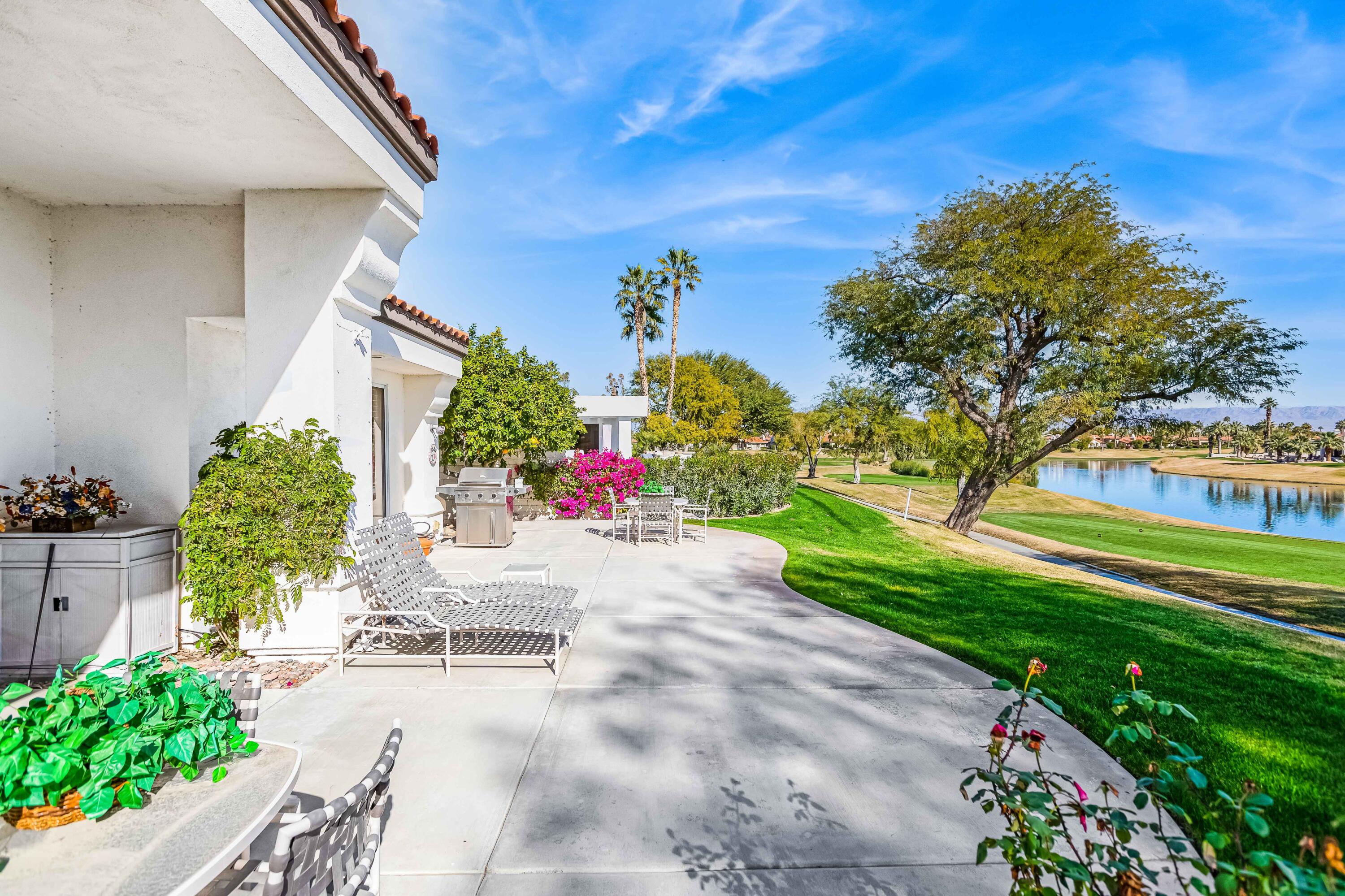 57600 Interlachen La Quinta, CA 92253 - Photo 75 of 87 a front view of a house with a yard and a garage