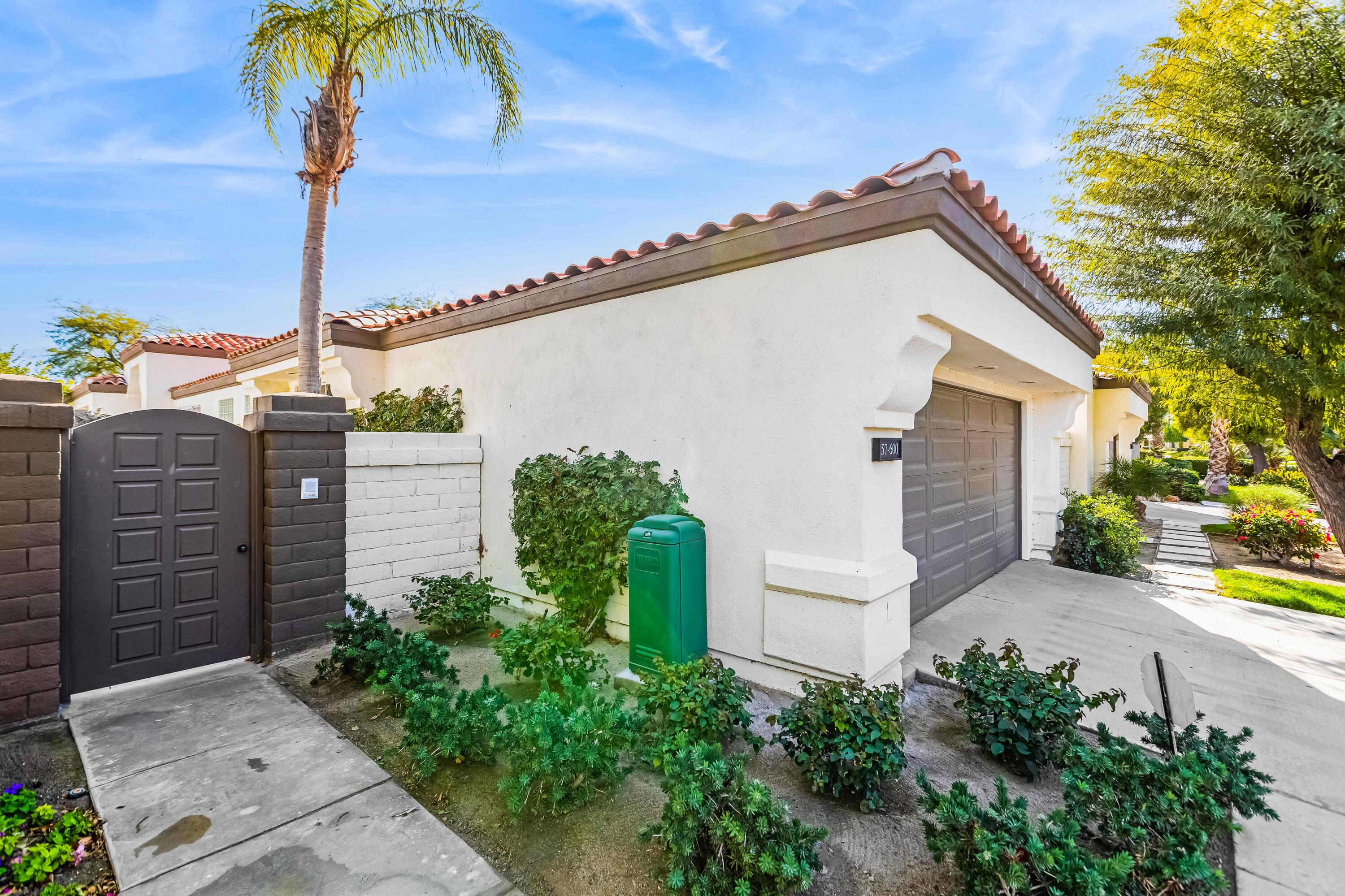 57600 Interlachen La Quinta, CA 92253 - Photo 9 of 87 a view of a house with a potted plant and iron fence