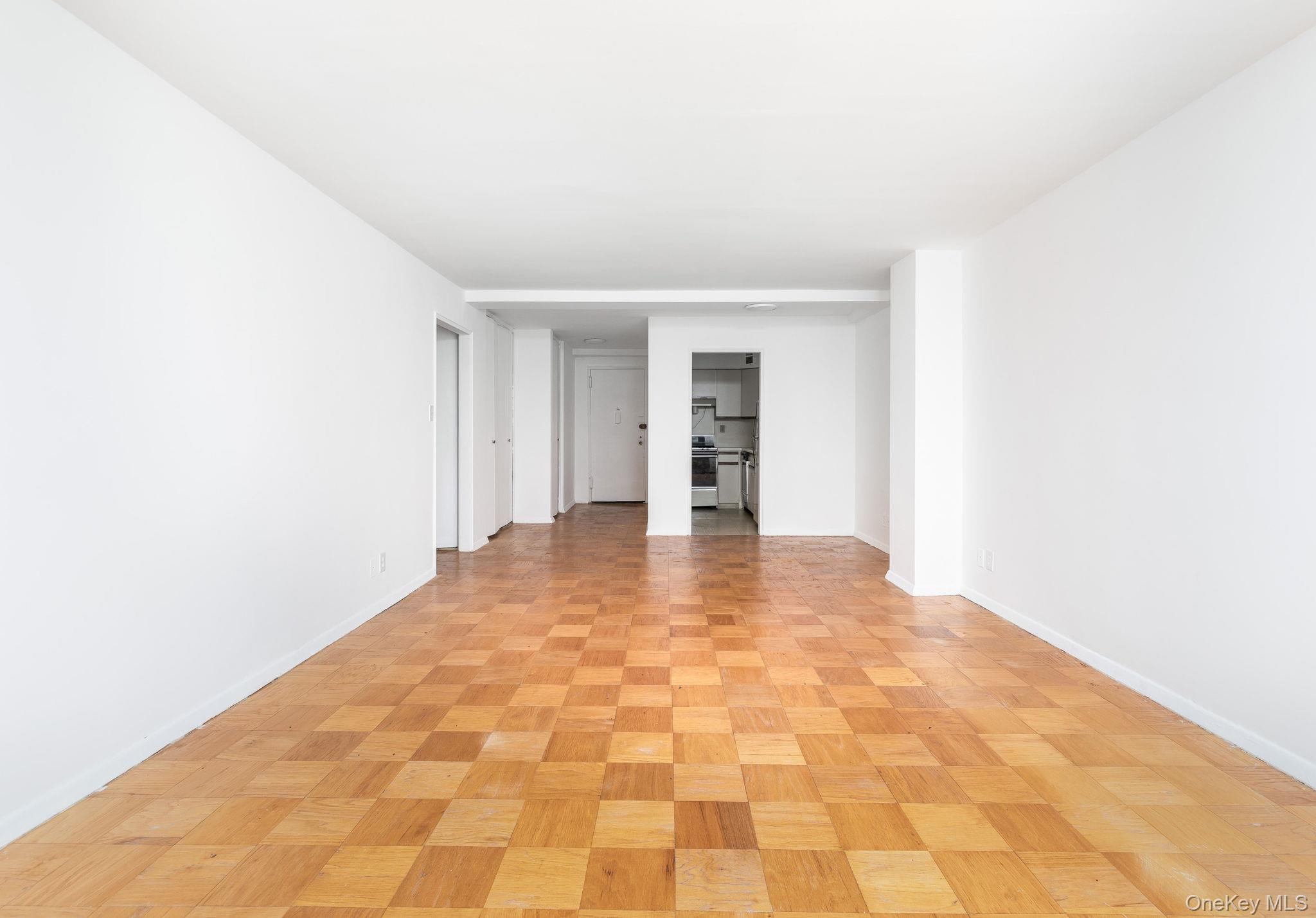 40 Brighton 1st Road, Unit 3J Brooklyn, NY 11235 - Photo 6 of 23 Empty room with light parquet flooring