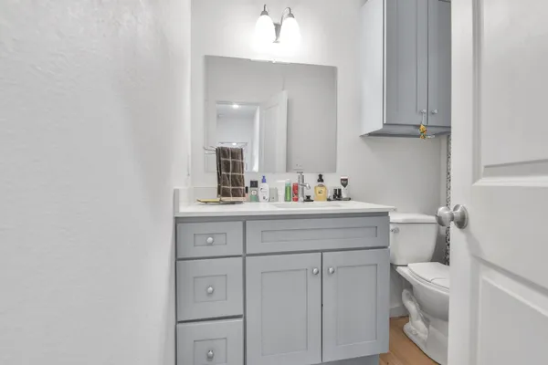 a bathroom with a sink vanity and mirror