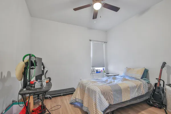 a bedroom with bed and a chandelier