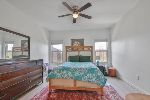 a bedroom with a bed and a large window