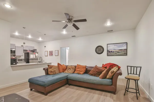 a living room with furniture and a painting on the wall