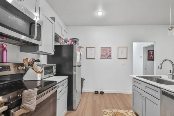 a kitchen with stainless steel appliances granite countertop a refrigerator and a sink