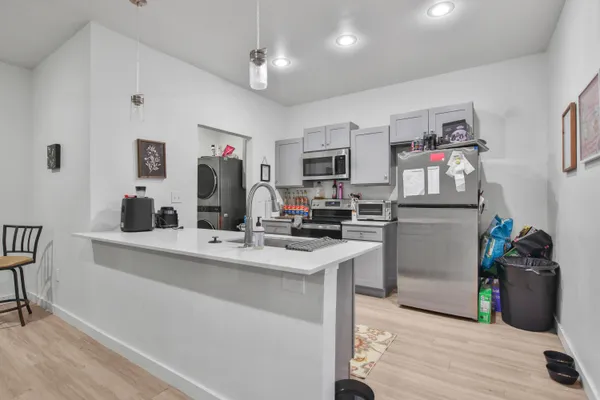 a kitchen with stainless steel appliances kitchen island granite countertop a stove and a refrigerator