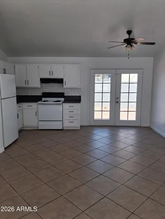 a kitchen with stainless steel appliances a sink stove and cabinets