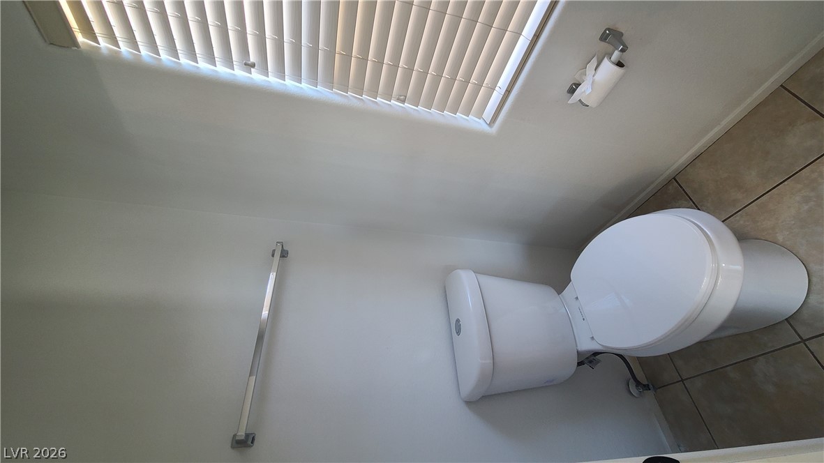 8944 Rutherford Grove Street Las Vegas, NV 89148 - Photo 20 of 35 A well-appointed powder room features a classic toilet and tile flooring.