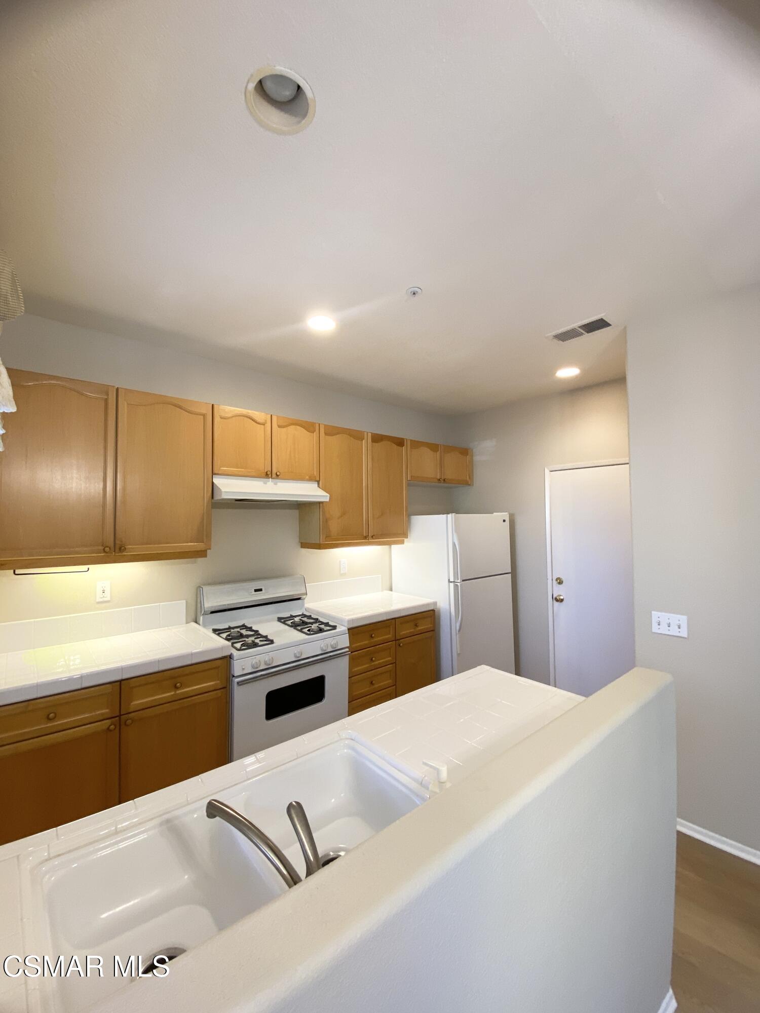 273 Springmist Lane Simi Valley, CA 93065 - Photo 8 of 14 a kitchen with a stove a sink and a refrigerator