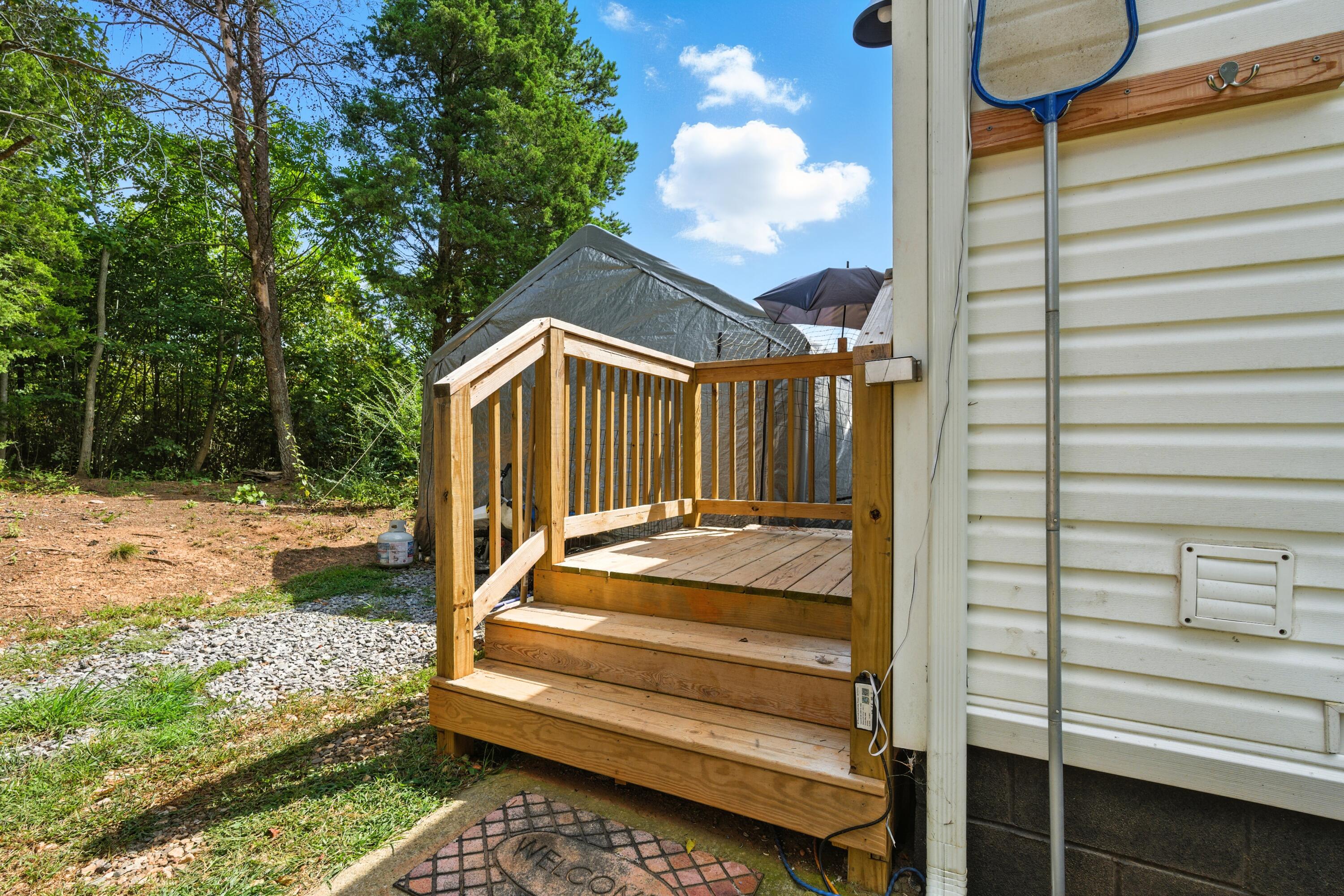 221 Cedar Court Gretna, VA 24557 - Photo 28 of 39 a view of backyard with deck and outdoor seating