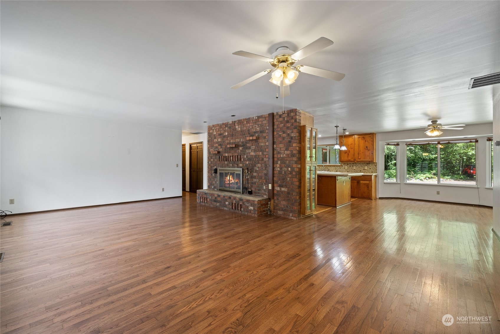 828 Lucas Creek Road Chehalis, WA 98532 - Photo 15 of 36 a view of an empty room with a window and wooden floor