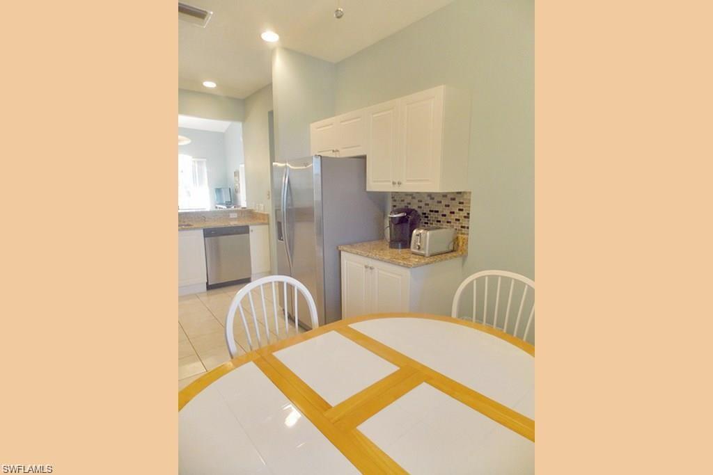 8365 Whisper Trace Way, Unit L203 Naples, FL 34114 - Photo 11 of 24 a living room with furniture and a window