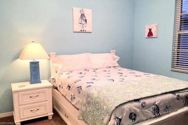 a bedroom with a bed and a night stand