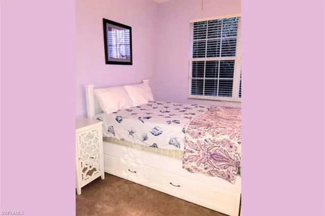 a bed room with a bed and a window