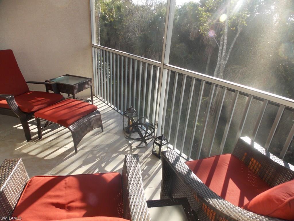 8365 Whisper Trace Way, Unit L203 Naples, FL 34114 - Photo 21 of 24 a view of a chairs and table in the balcony