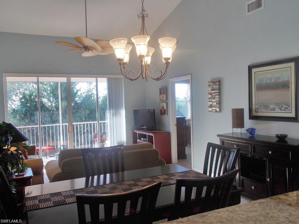 8365 Whisper Trace Way, Unit L203 Naples, FL 34114 - Photo 6 of 24 a view of a dining room with furniture window and outside view