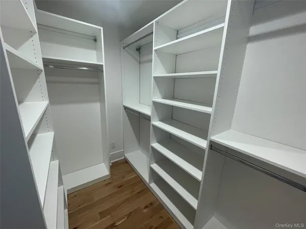 a view of walk in closet with empty racks