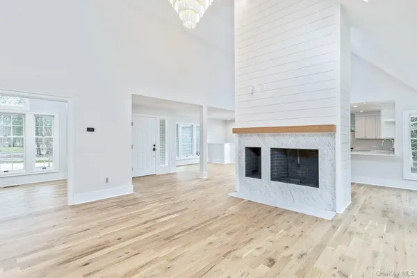 a view of a livingroom with wooden floor and a fireplace
