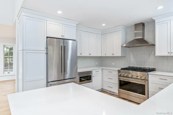 a kitchen with stainless steel appliances a stove a sink and a refrigerator