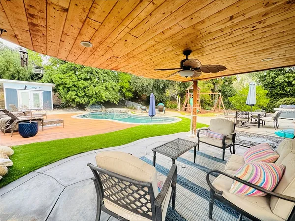 a swimming pool with outdoor seating space