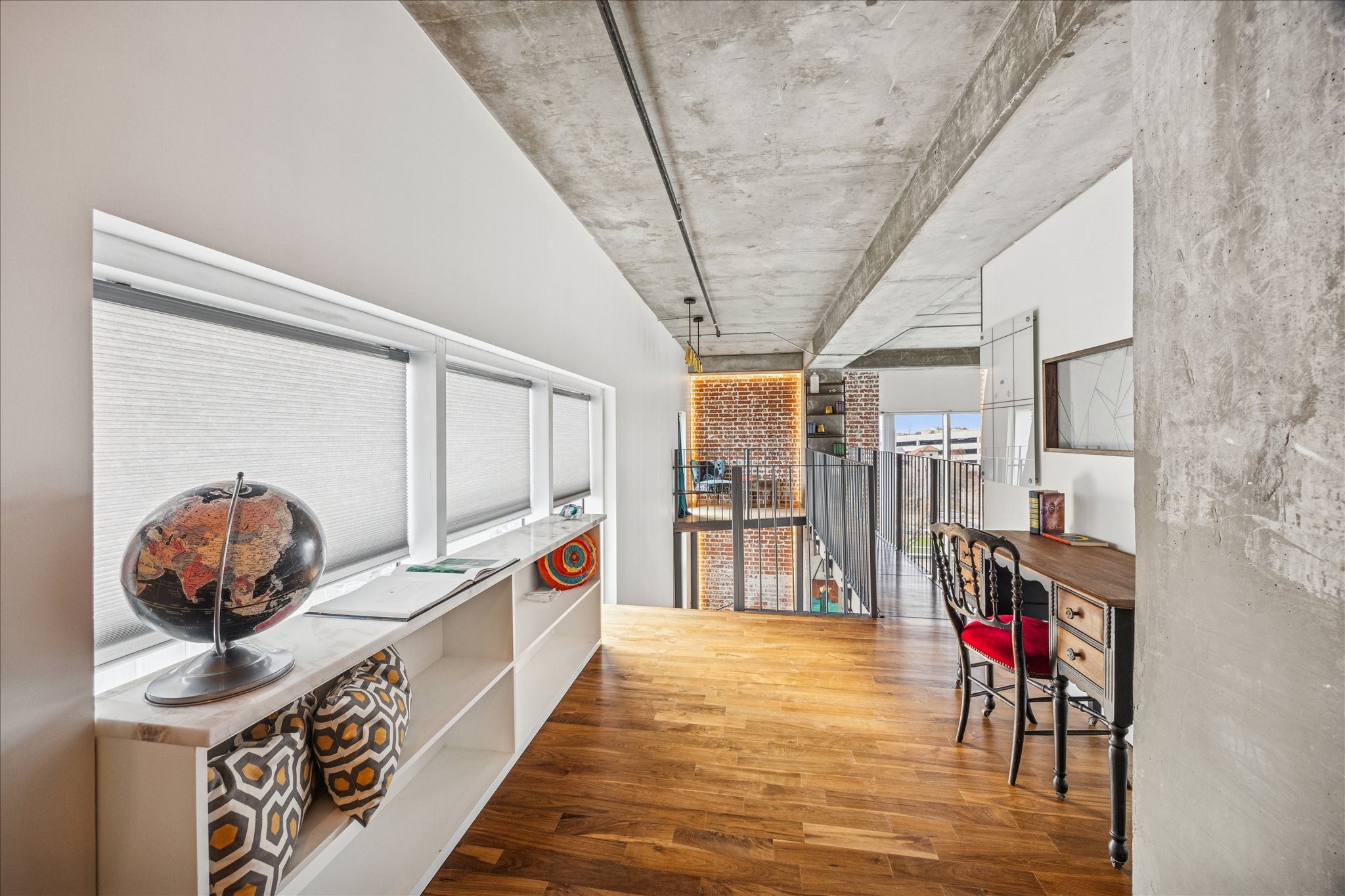 2000 Bagby Street, Unit 5400 Houston, TX 77002 - Photo 18 of 47 Second floor landing, custom walnut flooring on the second level leading to a reading nook. To the left, built in bookcase with marble countertop and touch automatic blind system.