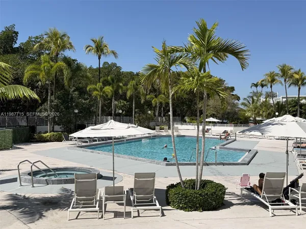 a view of a patio with table and chairs potted plants and palm tree