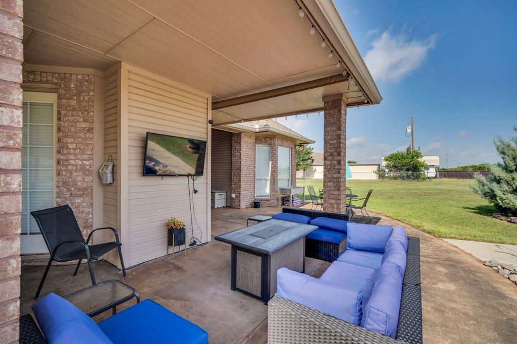 431 Mc Alpin Road Midlothian, TX 76065 - Photo 10 of 18 Covered patio with brick columns, concrete flooring, and string lighting