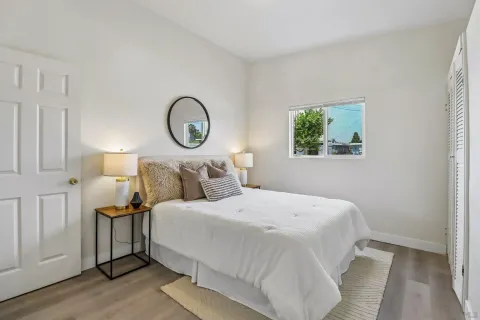 a bedroom with bed and a lamp