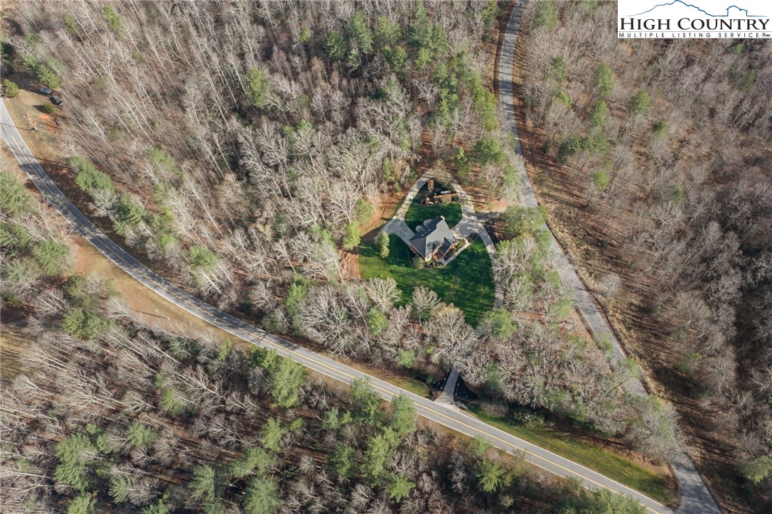 458 Jim Caudill Road Wilkesboro, NC 28697 - Photo 50 of 50 a view of a yard with plants and a bench