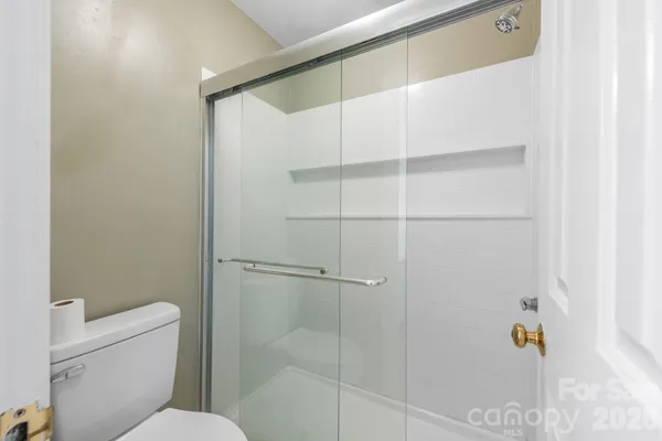 a bathroom with a shower and toilet