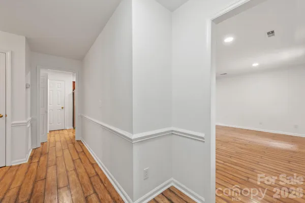 a view of a room with wooden floor